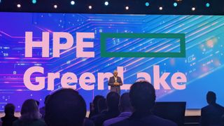 Keynote stage at HPE Discover Barcelona, with the words "HPE GreenLake" on stage. Standing on the stage is Antonio Neri, CEO at HPE.