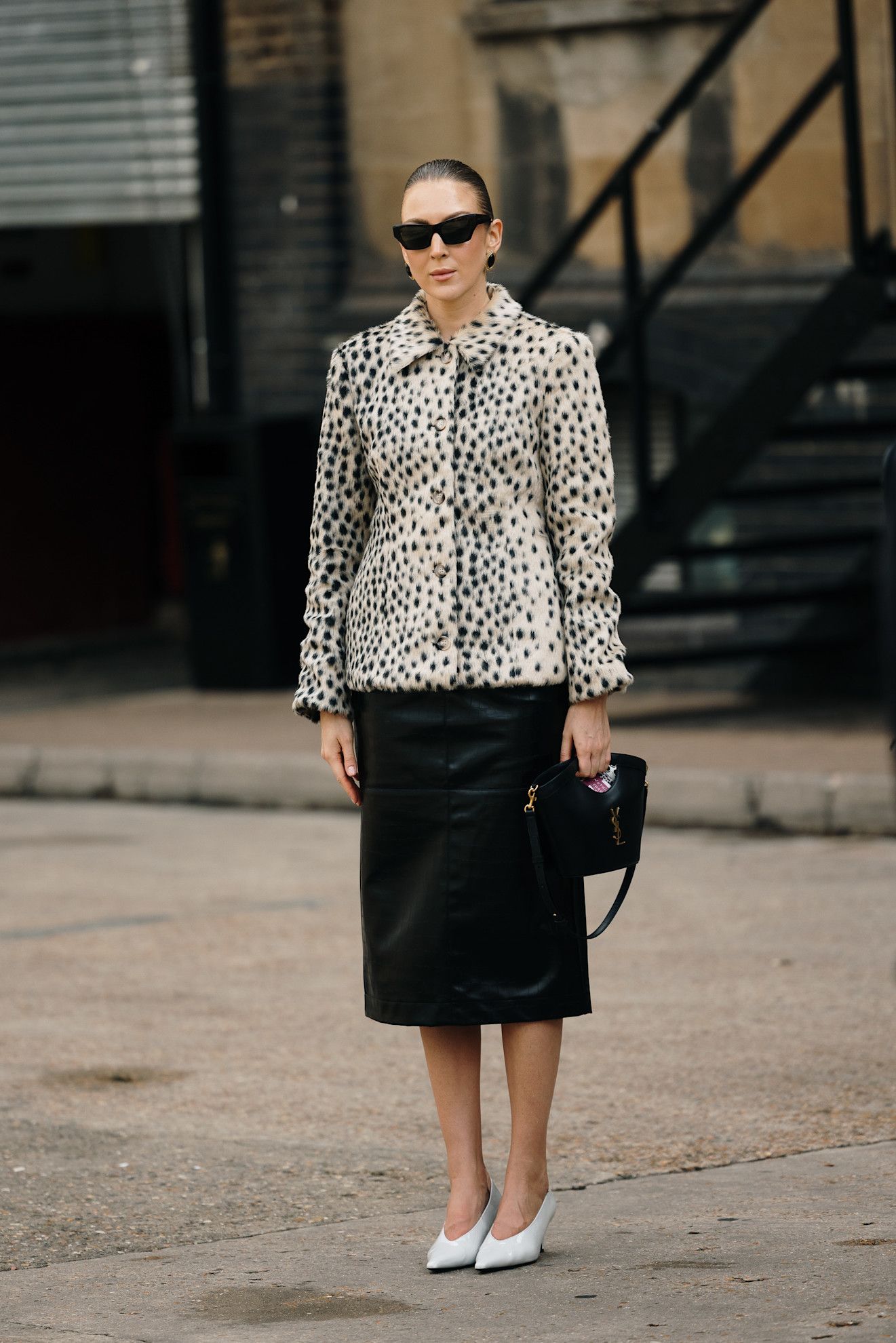woman wearing animal print jacket, skirt, and heels