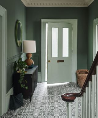 hallways with green painted walls and patterned floor tiles