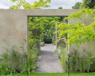 stone arch with path at the 'RHS Sanctuary' garden, designed by Ula Maria at RHS Hampton Court Palace Garden Festival