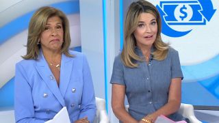 Hoda Kotb and Savannah Guthrie reunite on the Today desk. Hoda has on a blue suit and Savannah has on a blue dress. 