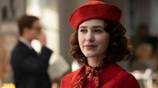 Midge Maisel in a red outfit with a red hat.