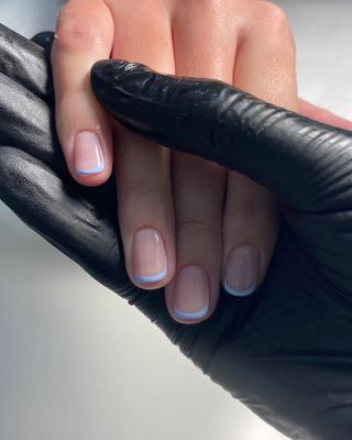 a pastel blue French tip manicure