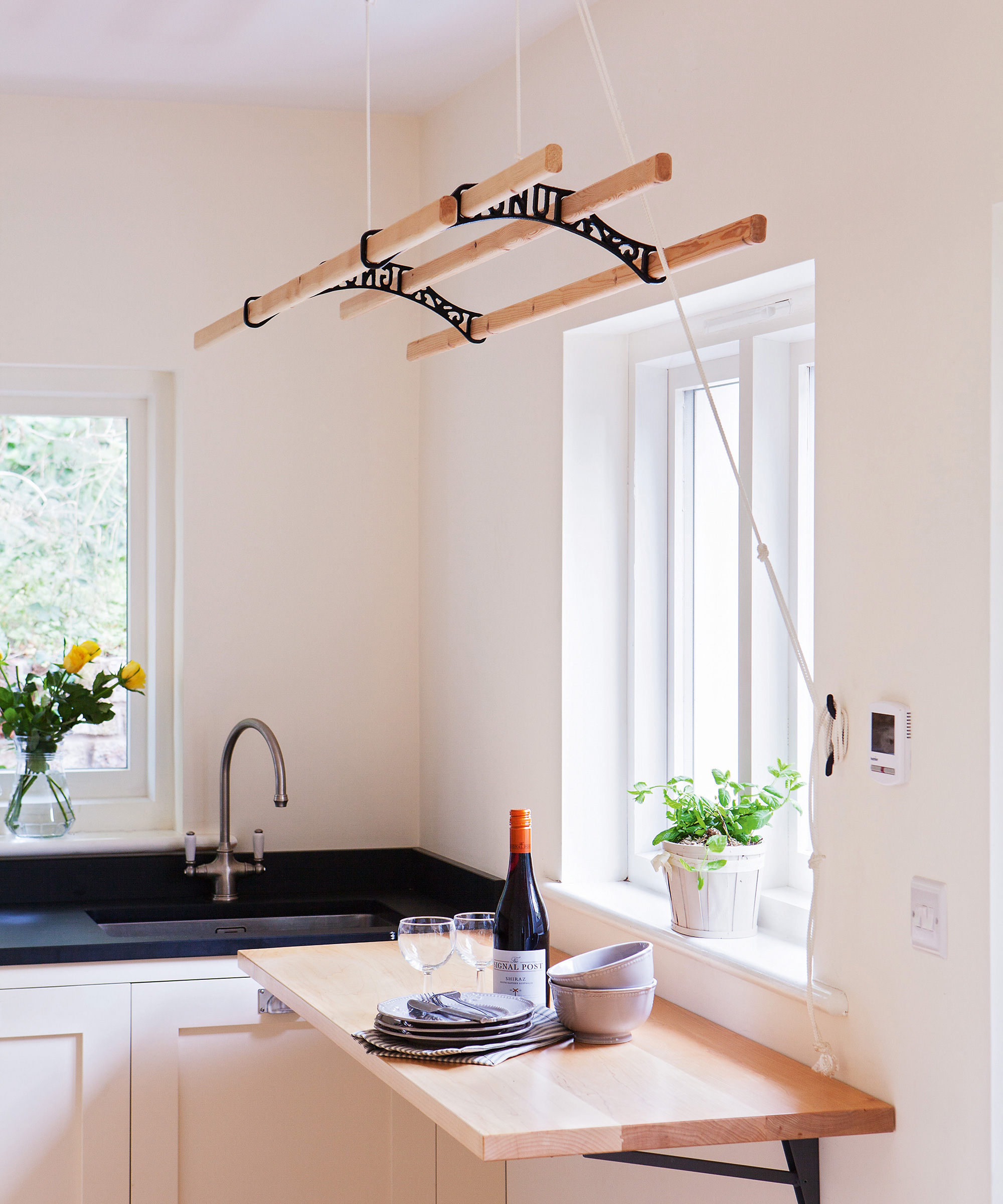 small kitchen utility room with hanging laundry rack