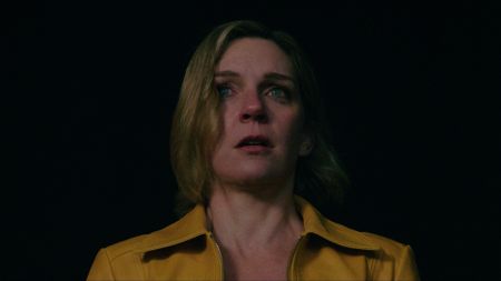 Rhea Seehorn as Carol Sturka, looking scared, in Pluribus.