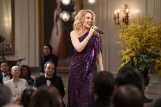 kylie minogue wearing a sparkly purple dress in the residence