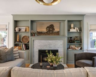 living room with gray-green cabinetry and neutral decor