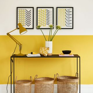 home office with yellow coloured and frames on wall