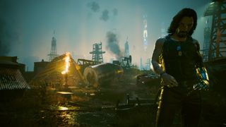 Cyberpunk 2077 screenshot of Johnny Silverhand in the oil fields of Night City. The city can be seen behind him.