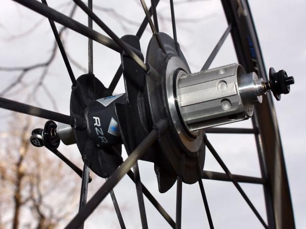 Lateral stiffness is provided with the two outermost flanges and their radially laced spokes but all drive torque is tranferred through the central flange.