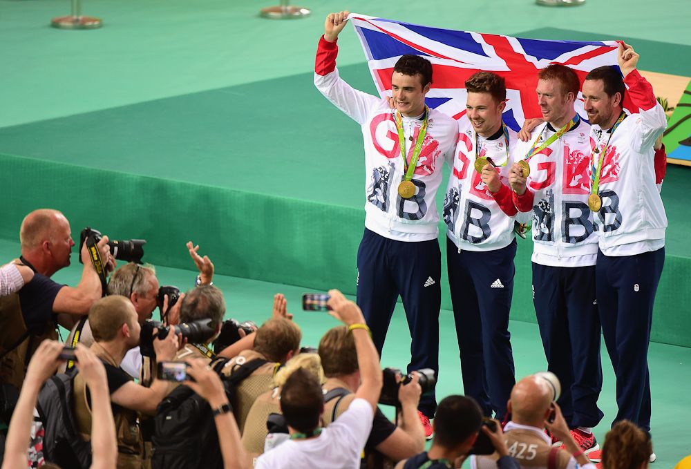 Gold medalists Steven Burke, Owain Doull, Edward Clancy and Bradley Wiggins of Team Great Britain pose for photographs after at the medal ceremony