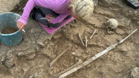Person uncovering the grave. 