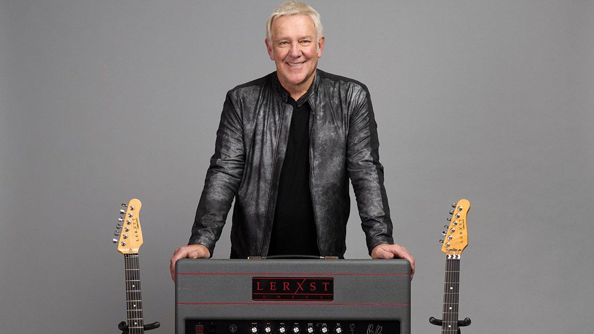 Alex Lifeson poses next to a Lerxst guitar amp and guitars