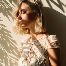 Woman in a wedding dress with shadows of plants