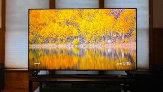 Hisense U9N TV showing colorful landscape image onscreen