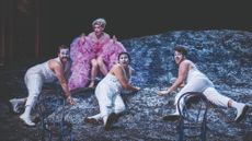 Performers on top of a rock mid-song
