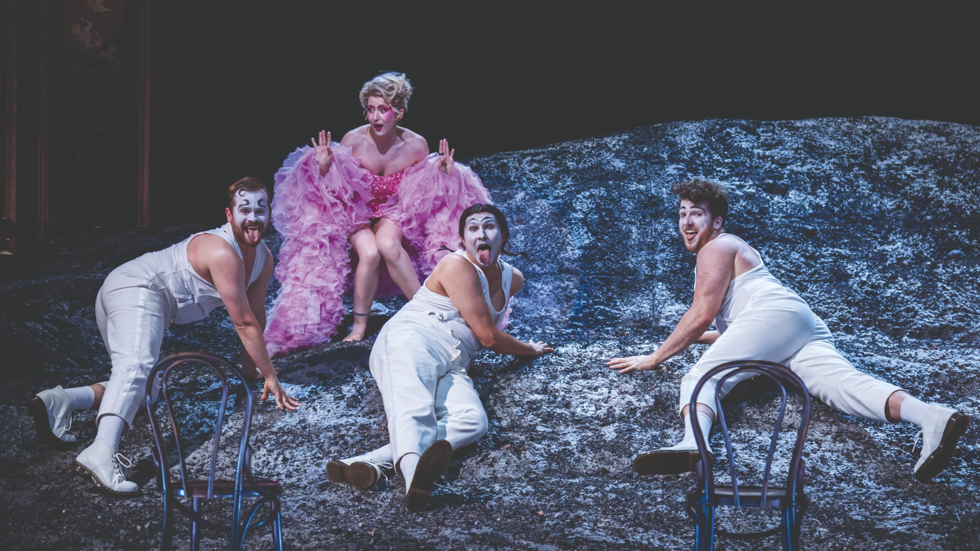 Performers on top of a rock mid-song