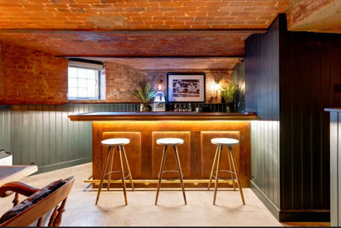 A bar in a brick cellar with under table lighting