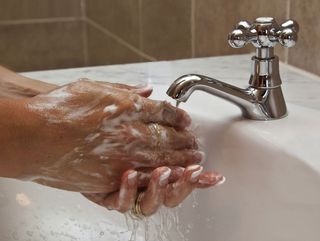 Soapy hands under a faucet. 