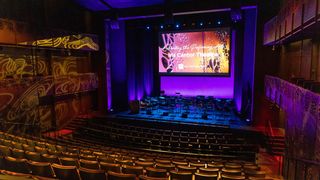 The interior of the Iris Cantor Theatre lit up in bright blue and red after Pro AV upgrade.