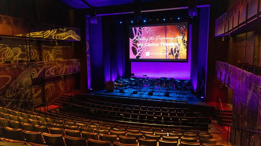  The interior of the Iris Cantor Theatre lit up in bright blue and red after Pro AV upgrade. 
