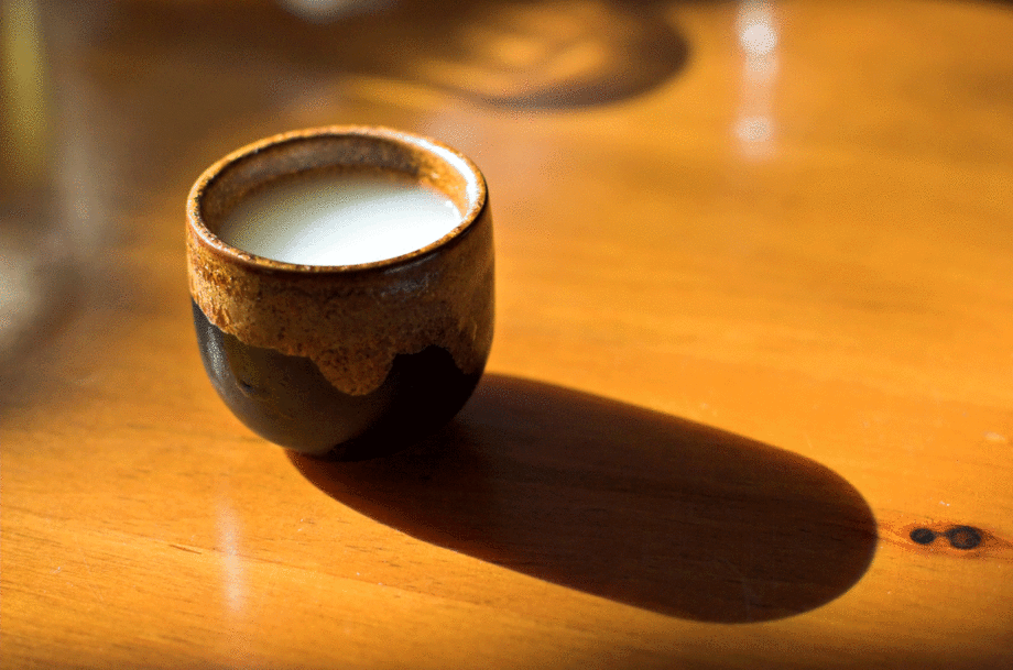 Cup of sake on table