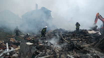 Rescuers conduct search and rescue operation at residential district after a Russian missile attack