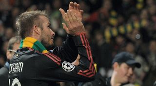 David Beckham wearing a gold and green scarf at Old Trafford in 2010 after playing against Manchester United for AC Milan.
