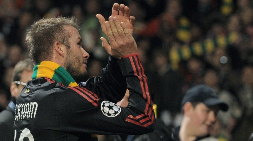 David Beckham wearing a gold and green scarf at Old Trafford in 2010 after playing against Manchester United for AC Milan.