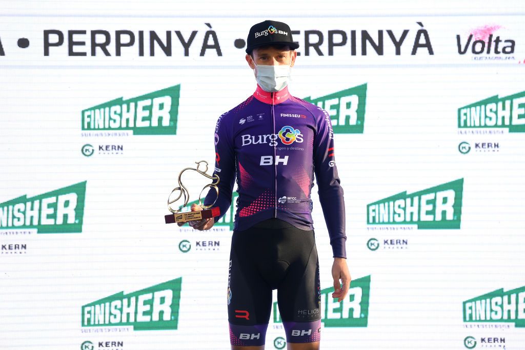 PERPIGNAN FRANCE MARCH 22 Adria Moreno of Spain of Spain and Team Burgos BH celebrates winning the trophy for the most combative rider on the podium ceremony after the 101st Volta Ciclista a Catalunya 2022 Stage 2 a 2024km stage from LEscala to Perpignan VoltaCatalunya101 WorldTour on March 22 2022 in Perpignan France Photo by David RamosGetty Images