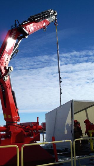 A geothermal probe begin lowered into the borehole on the Ross Ice Shelf.