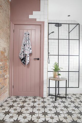 Bathroom with patterned tile floor, Crittal-style shower screen, white metro tiles and pink wall and door paint