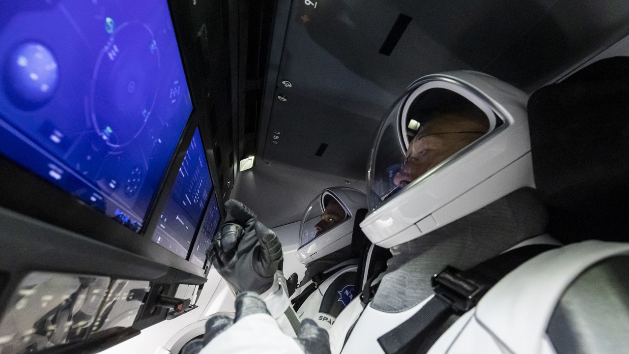 NASA astronauts Doug Hurley and Bob Behknen perform a launch dress rehearsal inside their SpaceX Crew Dragon spacecraft