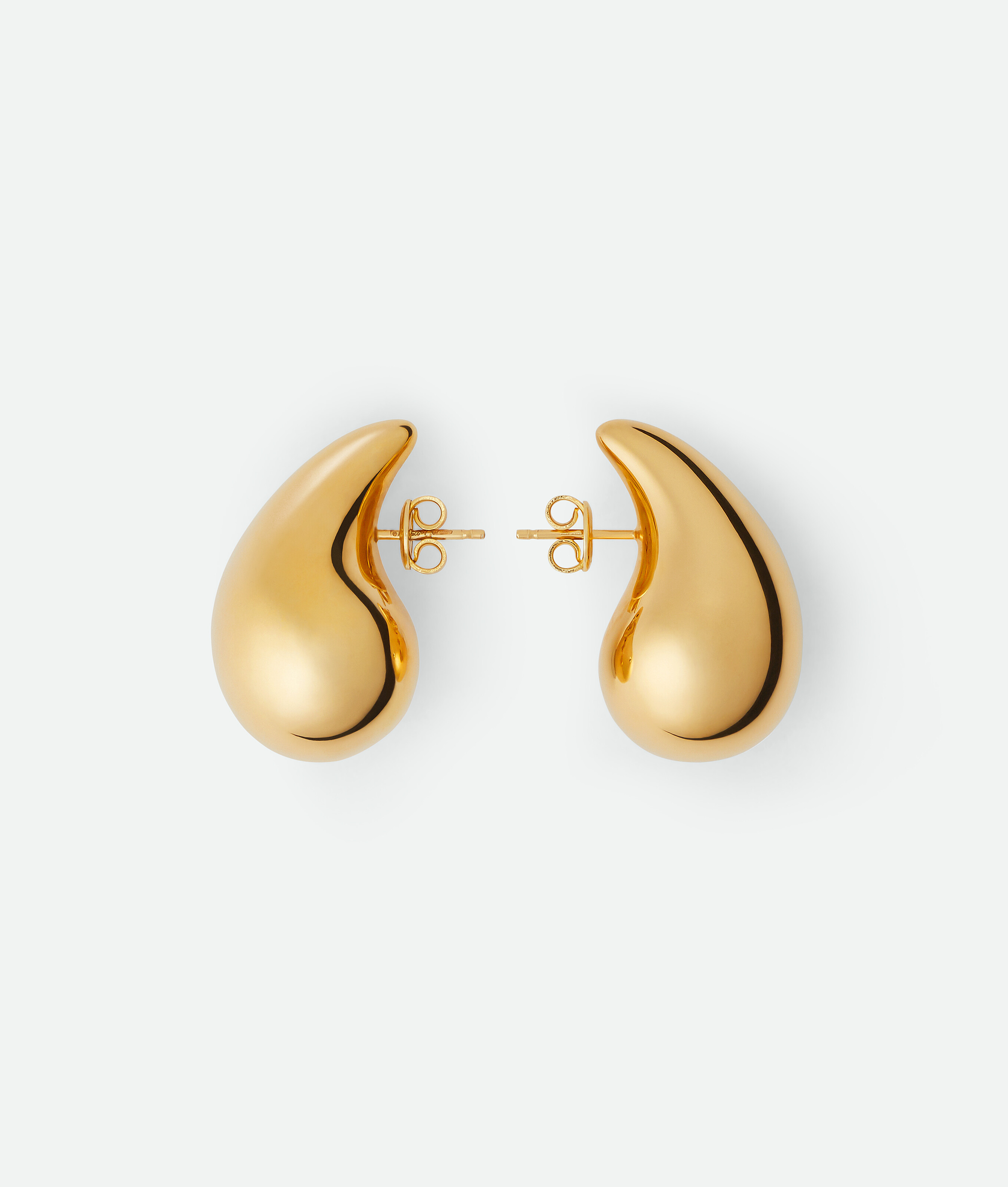 Small Drop Earrings in front of a plain backdrop