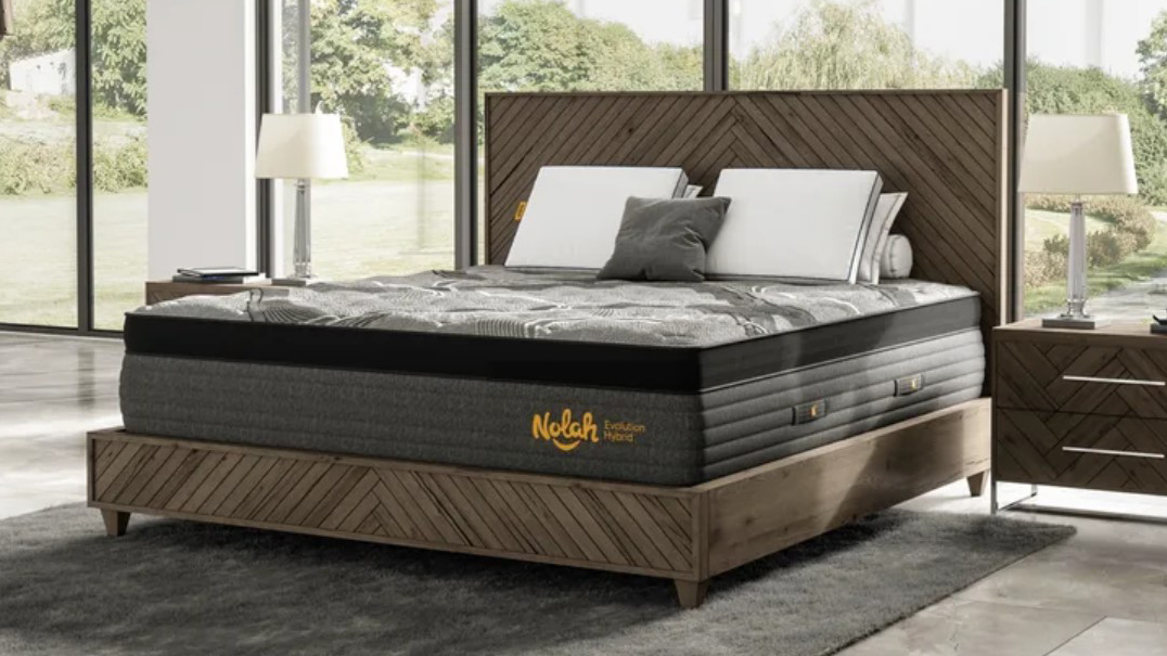 Best mattress: the Nolah Evolution 15 Mattress on a deep brown wooden bed frame