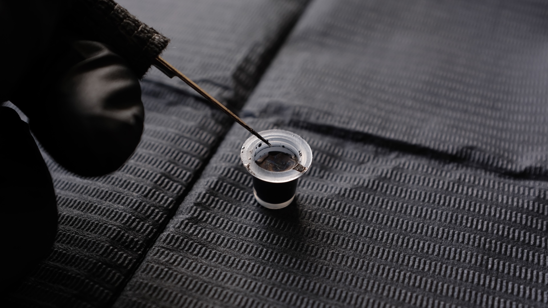 a close-up of a tattoo needle and ink