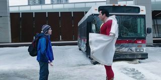 Freddy and adult Billy next to bus in Shazam!