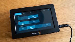 Blackmagic Video Assist 5 3G video monitor on a wooden surface