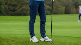 A golfer wears the adidas Women's Ultimate365 COLD.RDY Golf Pants