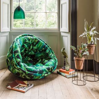 cocoon chair with foliage print and plants on pots