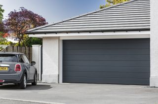 A single storey garage with an electric garage door