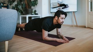 Man doing plank exercise at home
