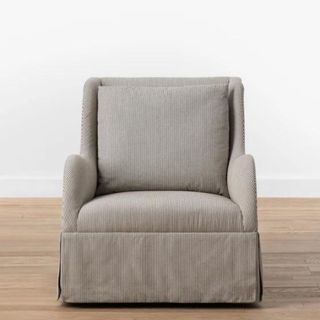 A gray armchair with subtle stripes 
