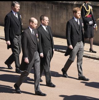Prince William, Duke of Cambridge, Peter Phillips, Prince Harry, Duke of Sussex, Vice-Admiral Sir Timothy Laurence follow Prince Philip, Duke of Edinburgh's coffin as it arrives at St George's Chapel during the funeral of Prince Philip, Duke of Edinburgh at Windsor Castle on April 17, 2021