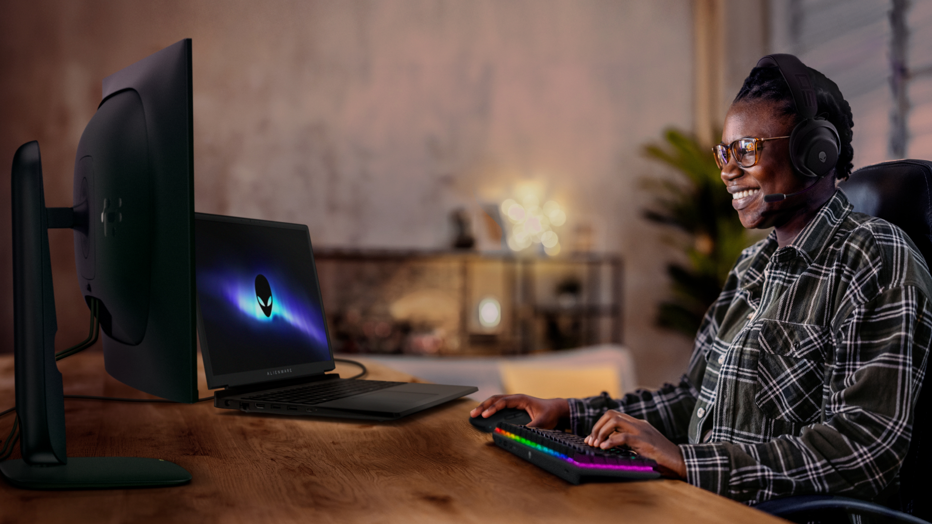 Aman smiles as he plays games on his Alienware 15 laptop