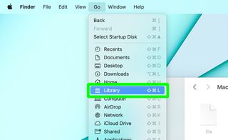 The "Go" menu is open in macOS finder to Library, looking for the hidden files in a Mac on macOS