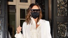 Victoria Beckham wearing a satin shirt, white blazer and oversized sunglasses in Manhattan on May 24, 2021