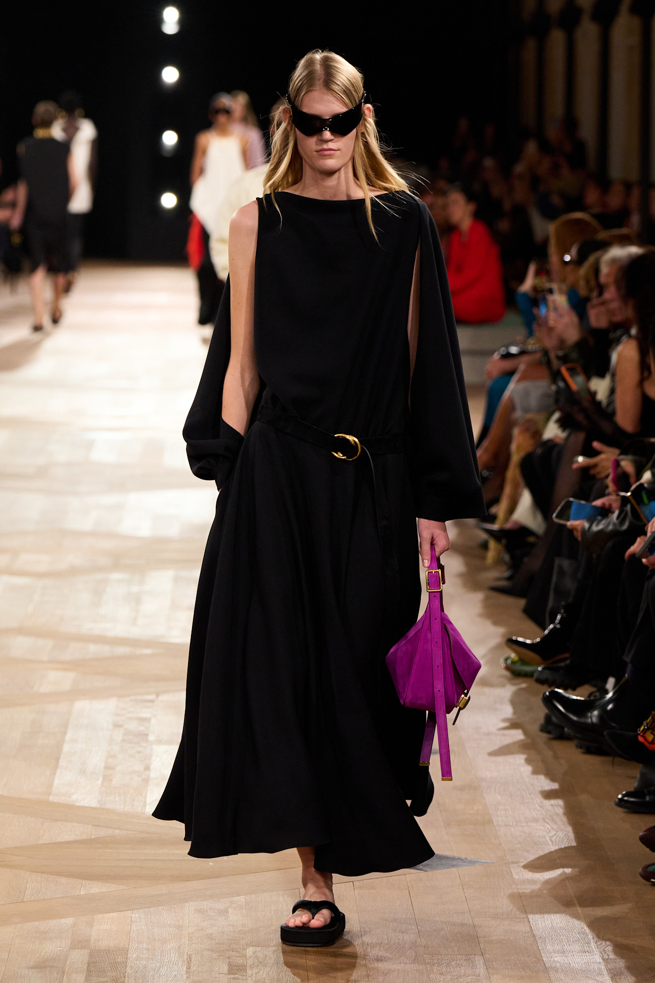 Balenciaga Spring/Summer 2026 model wearing a black dress and chunky flip flops.