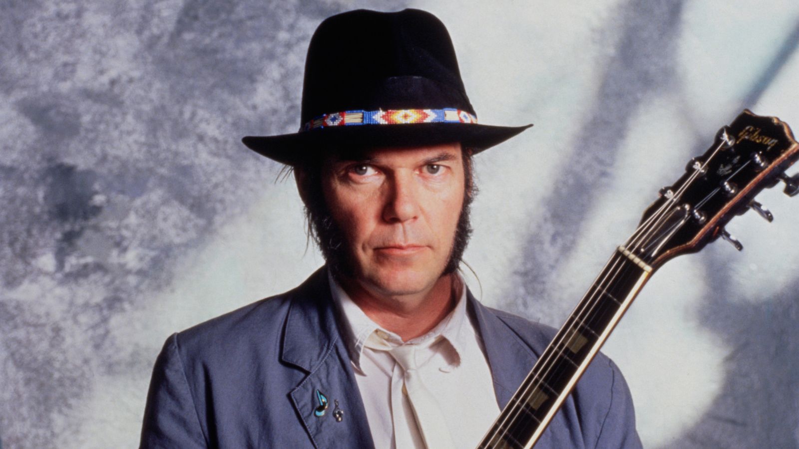 neil young on a gray background in the '80s
