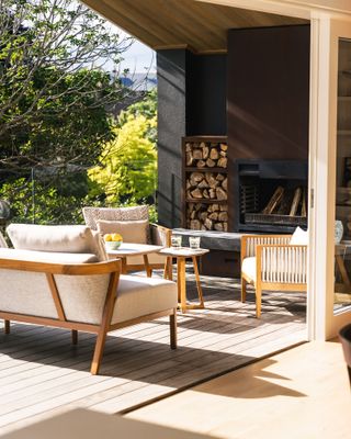 outdoor living room with wood seating and sofa